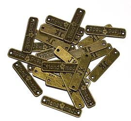 Naszywany znaczek mosiądz 25x6 mm HAND MADE